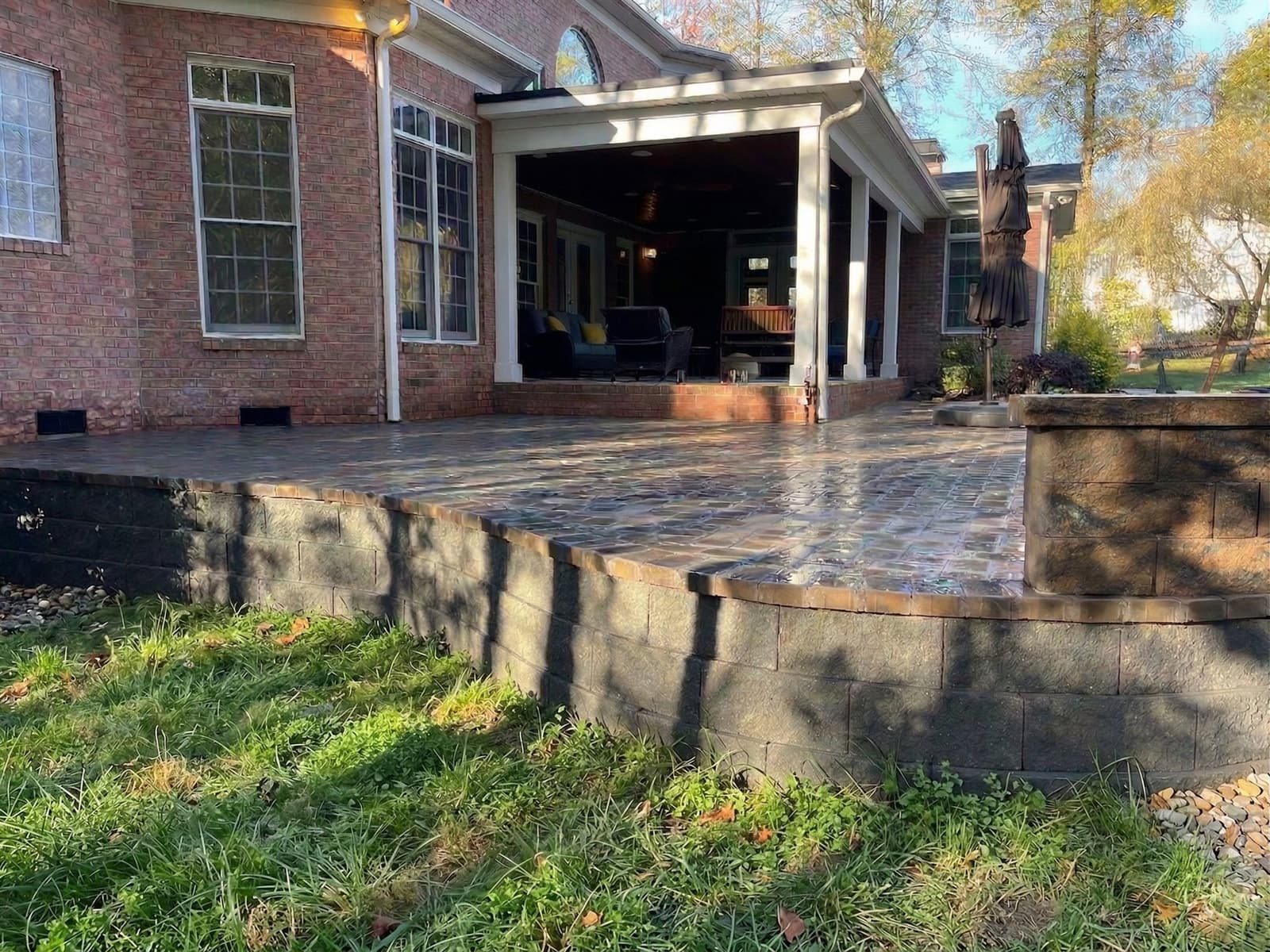 Completed paver patio whose flat, even surface reflects the compacted base beneath it