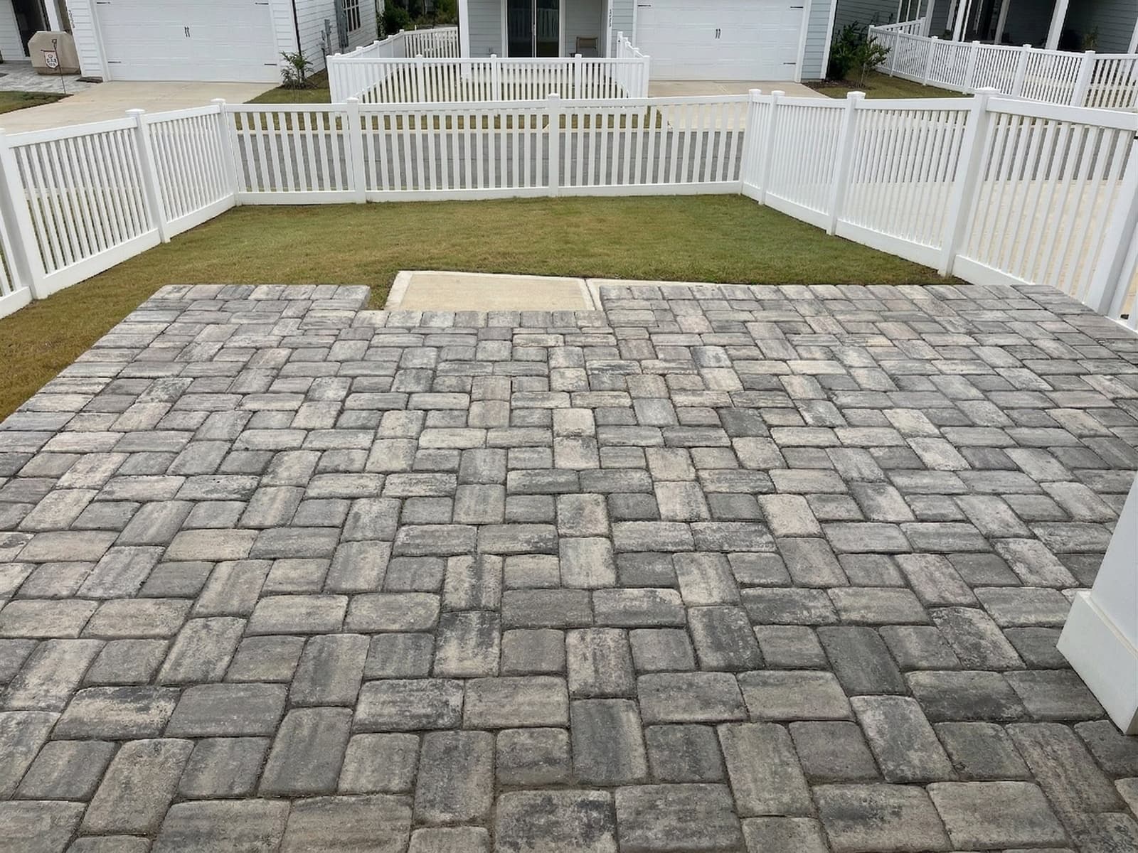 Paver patio covering part of a backyard, the hardscape area that counts toward lot coverage
