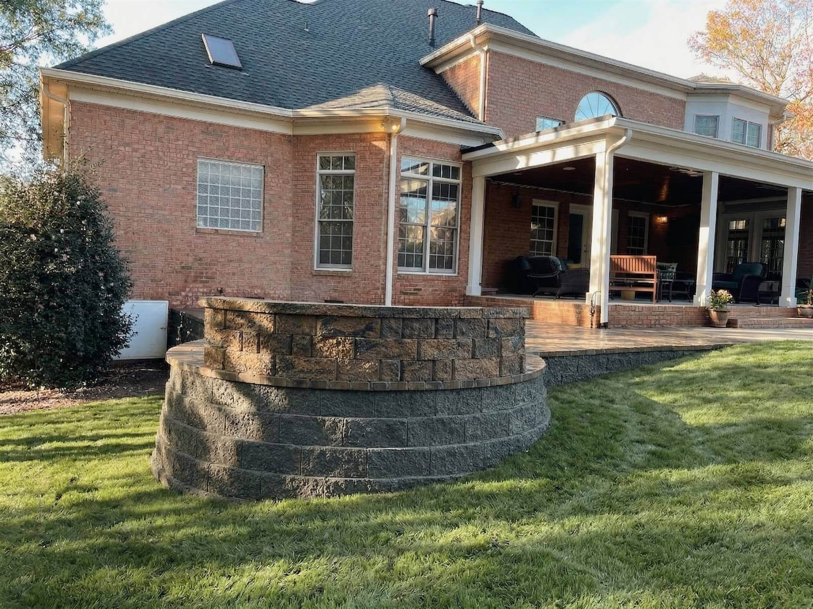 Paver patio with a capped sitting wall, the kind of layout an HOA committee reviews
