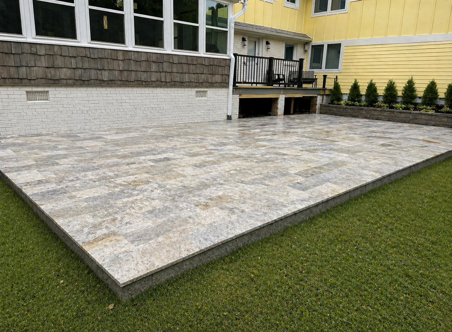 Paver patio perimeter where the border course meets the surrounding lawn