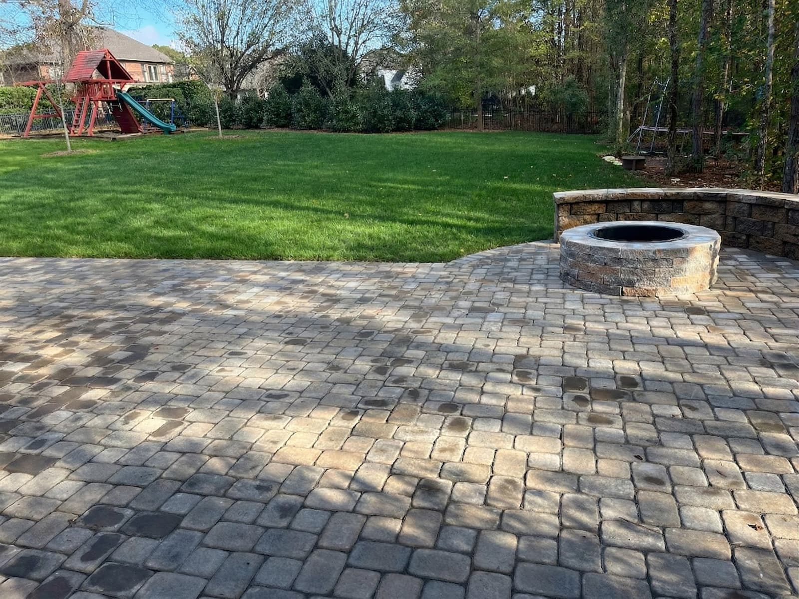 Paver patio meeting the rear of a home with a clean transition at the threshold